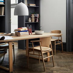 Fritz Hansen Nendo Dining Chairs in Oak in room with Cecilie Manz Essay Table