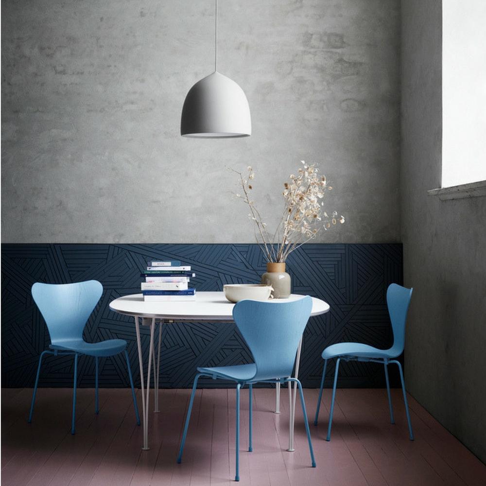 Fritz Hansen Super Elliptical Table in room with Trieste Blue Series 7 Chairs and Suspense Pendant Light