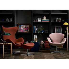 Fritz Hansen Arne Jacobsen Egg Chair and Footstool in Dark Orange in room with Light Pink Swan Chair
