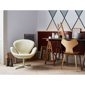 Fritz Hansen Swan Chair in room with Grand Prix Chair