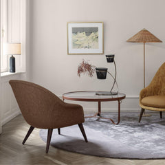 GUBI Gravity Table Lamp by Space Copenhagen in room with Paavo Tynell Floor Lamp, Adnet Coffee Table, and Bat Lounge Chairs