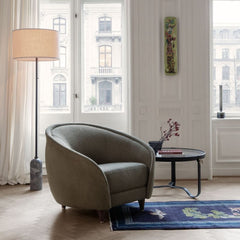 GUBI Revers Lounge Chair in room with Gravity Floor Lamp and Adnet Coffee Table