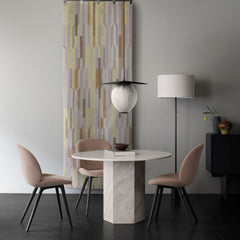GUBI Satellite Pendant in room with Beetle Dining Chairs and Round Epic Table in Travertine