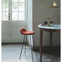 Gubi Semi Pendant in Brass in room with marble table and 3D Stool by Komplot Design