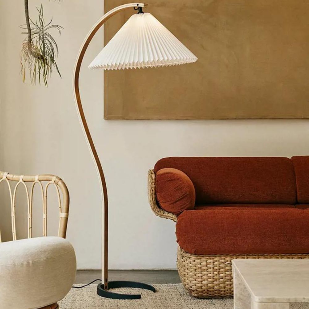 Gubi Timberline Floor Lamp in room with Basket Sofa and Grace Chair