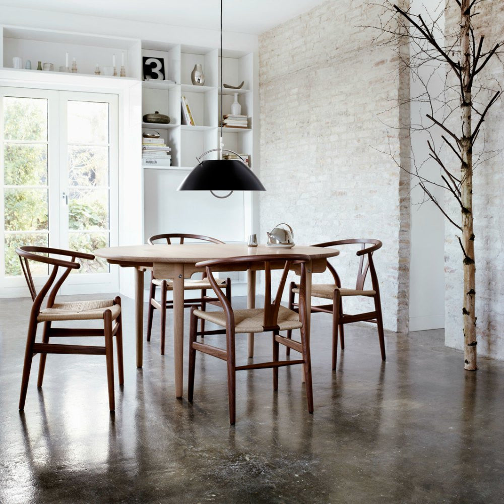 Walnut Wegner Wishbone Chairs in Dining Room with Louis Poulsen Light