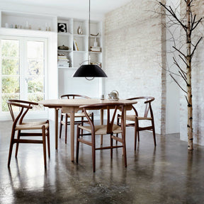 Walnut Wegner Wishbone Chairs in Dining Room with Louis Poulsen Light