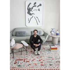 Jaime Hayon in his living room with Hayon x Nani Rug, Favn sofa, and palette coffee table