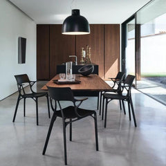 Kartell A.I. Chairs by Philippe Starck in Dining Room with floating Walnut Table