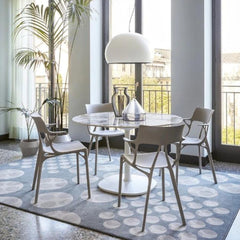 Kartell A.I. Chairs by Philippe Starck in Dining Room with Round Marble Table