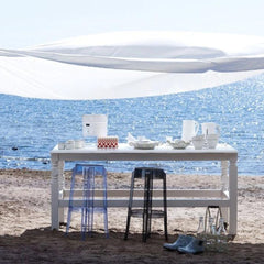 Kartell Charles Ghost Stools Powder Blue and Smoke Grey outdoors by Ocean