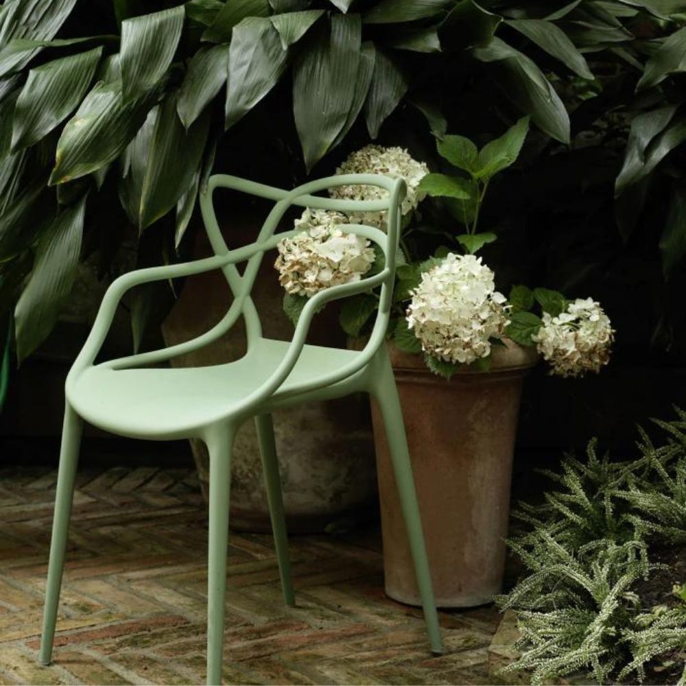 Kartell Masters Chair Sage Green Outdoors with Plants and Hydrangeas