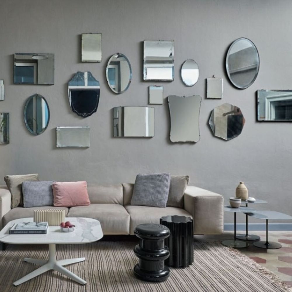 Kartell Thierry Side Tables by Piero Lissoni in room with sofa and mirrors