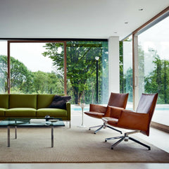 Knoll Pilot Swivel Chairs by Barber Osgerby in room with Barcelona Table and Dark Green Sofa