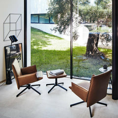 Knoll Leather Pilot Swivel Lounge Chairs by Barber Osgerby in room with floor to ceiling windows