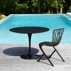 Knoll Saarinen Outdoor Table Black with Slate Top by pool with Adjaye Washington Skeleton Chair
