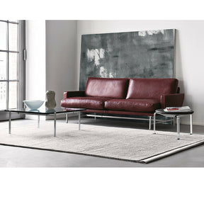 Piero Lissoni Two Seat Sofa Burgandy Leather in Room with Poul Kjaerholm Table and Stool