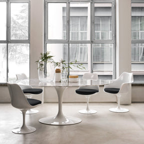 White Saarinen Tulip Chairs with Black Cushions around Oval Marble Saarinen Table Knoll