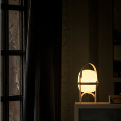 Miguel Milá Cestita Table Lamp at Night on Table by Santa & Cole