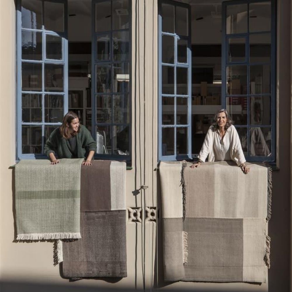 Nani Marquina and Elisa Padron with Tres Rugs in windows