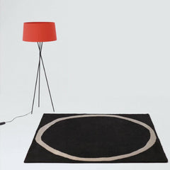 Santa and Cole Tripode Lamp with Red Amber Shade in Room with Nani Marquina Aros Rug