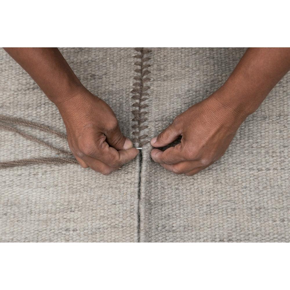 Nani Marquina Mia Rug stitching detail with hands of maker