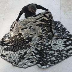 Nani Marquina Losanges Rug Black and Ivory being unfolded