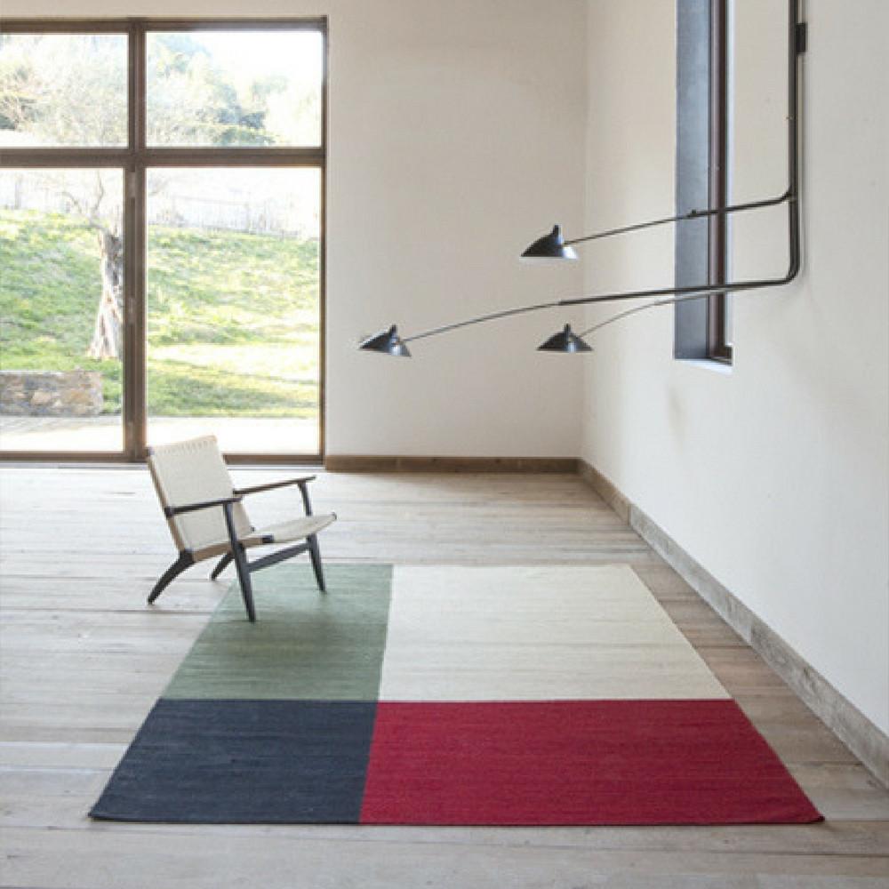 Nani Marquina Melange Rug Color 1 in Room with Wegner CH25 Chair and Serge Mouille Lamp