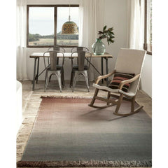 Nani Marquina Shade Rug Palette 4 Stormy Grey Sunset in room with rocking chair and Tolix chairs