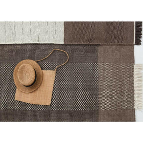 Nani Marquina Tres Rug Chocolate Detail with straw hat