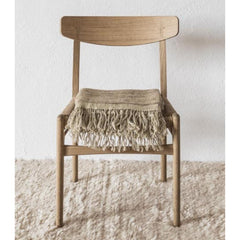 Nanimarquina Ilse Crawford Wellbeing Wool Chobi Rug in room with Throw and Wegner CH23 Chair
