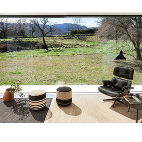 Nanimarquina Kilim Poufs in room with Herb Rugs, Eames Lounge, and Mantis Lamp