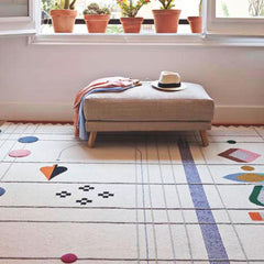 Nanimarquina Rabari rug by Doshi Levien styled in room with ottoman