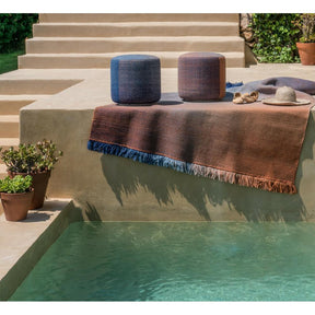 Nanimarquina Shade poufs and rug by pool