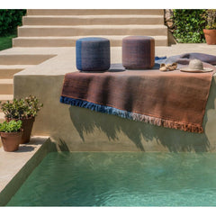 Nanimarquina Shade poufs and rug by pool