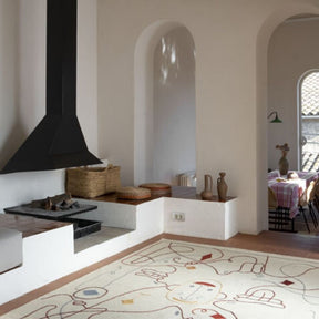 Nanimarquina Silhouette Rug by Jaime Hayon by Fireplace.