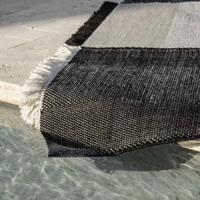 nanimarquina Tres Outdoor Black rug by pool