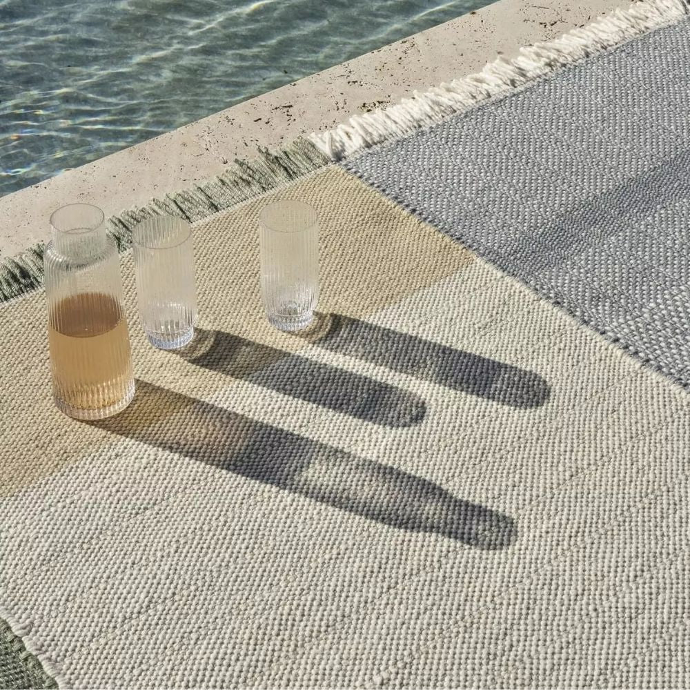 nanimarquina Tres Outdoor Sage Rug by Pool with cold drinks