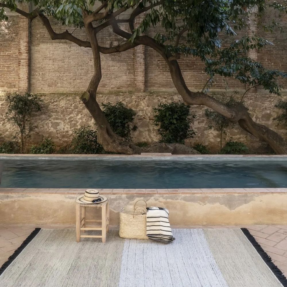 nanimarquina Tres Outdoor Stripes Rug Black by Pool