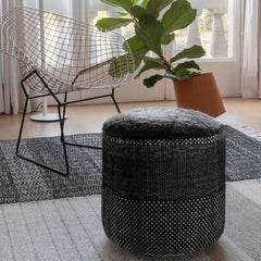 nanimarquina Tres Persian Pouf Black in room with Bertoia Diamond Chair and Plant