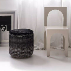 nanimarquina Tres Persian Pouf Black in room with Chair and Artwork