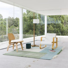 Nanimarquina Tres Rug Green in room with Eames and Alvar Aalto Chairs