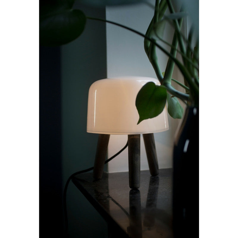 Norm Architects Milk Table Lamp with Light on a Table