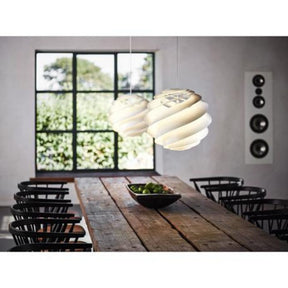 Pair of Le Klint Swirl 3 Pendant Lights above Dining Room Table