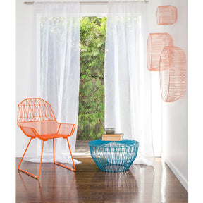 Bend Orange Farmhouse Chair in Room with Peacock Blue Drum Table