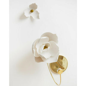 PELLE Lure Magnolia Sconce and flower on wall in studio
