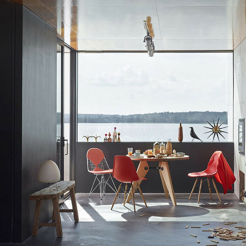 Prouve Gueridon Table in room with Eames Chairs by Window to Lake Como Vitra