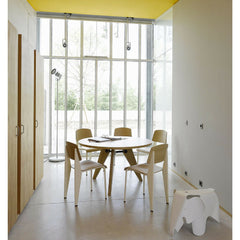 Prouve Gueridon Table in room with Standard Chairs Yellow Ceiling Vitra