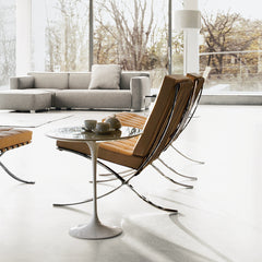 Saarinen Side Table in room with Barcelona Chairs and Barber Osgerby Sofa