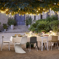 Vitra APC Chairs outdoors with Panton Chair and Hall Chairs under Cozy Lights Spring 2023